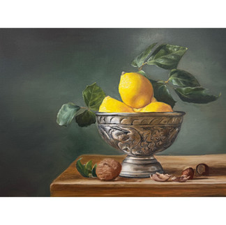 Still life oil painting of a silver ornate bowl holding bright yellow lemons with green leaves, set on a wooden surface with scattered walnut shells.