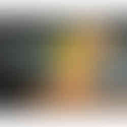 Still life oil painting of a silver ornate bowl holding bright yellow lemons with green leaves, set on a wooden surface with scattered walnut shells.