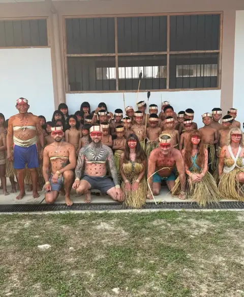 amazonian adventure where lewis and others are pictured with the matses tribe