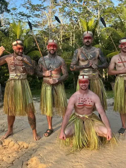 amazonian adventure where lewis and others are pictured with the matses tribe