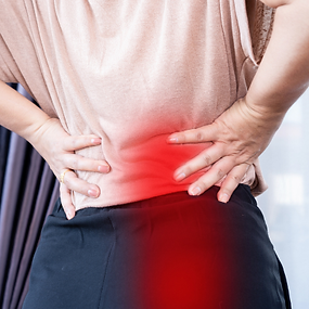 Person with sciatica showing lower back and leg pain radiating from the spine