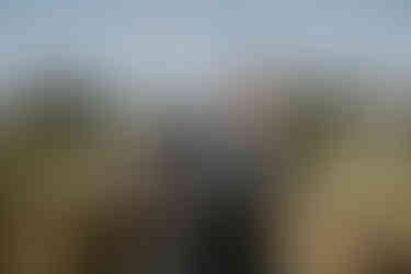 Groomsmen pouring a giant bottle of champagne