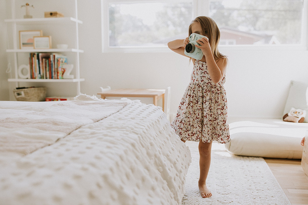 Girl holding Instax camera
