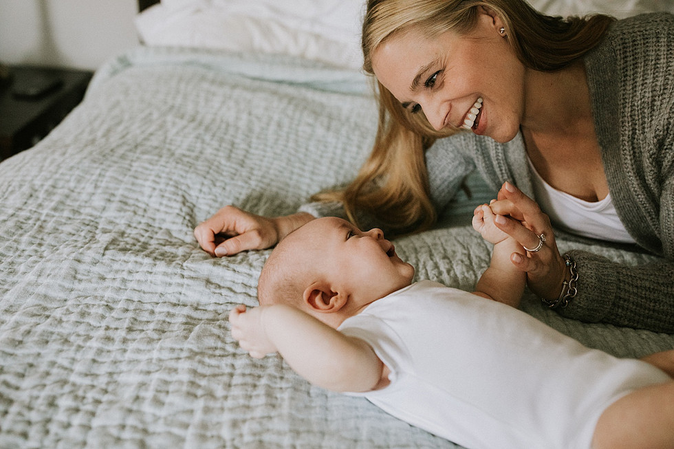 Mother smiling at newborn baby