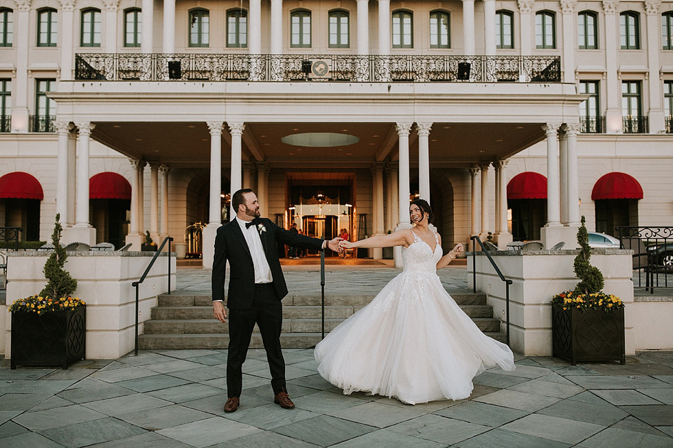 Groom dancing with bride outside Pittsburgh wedding venue