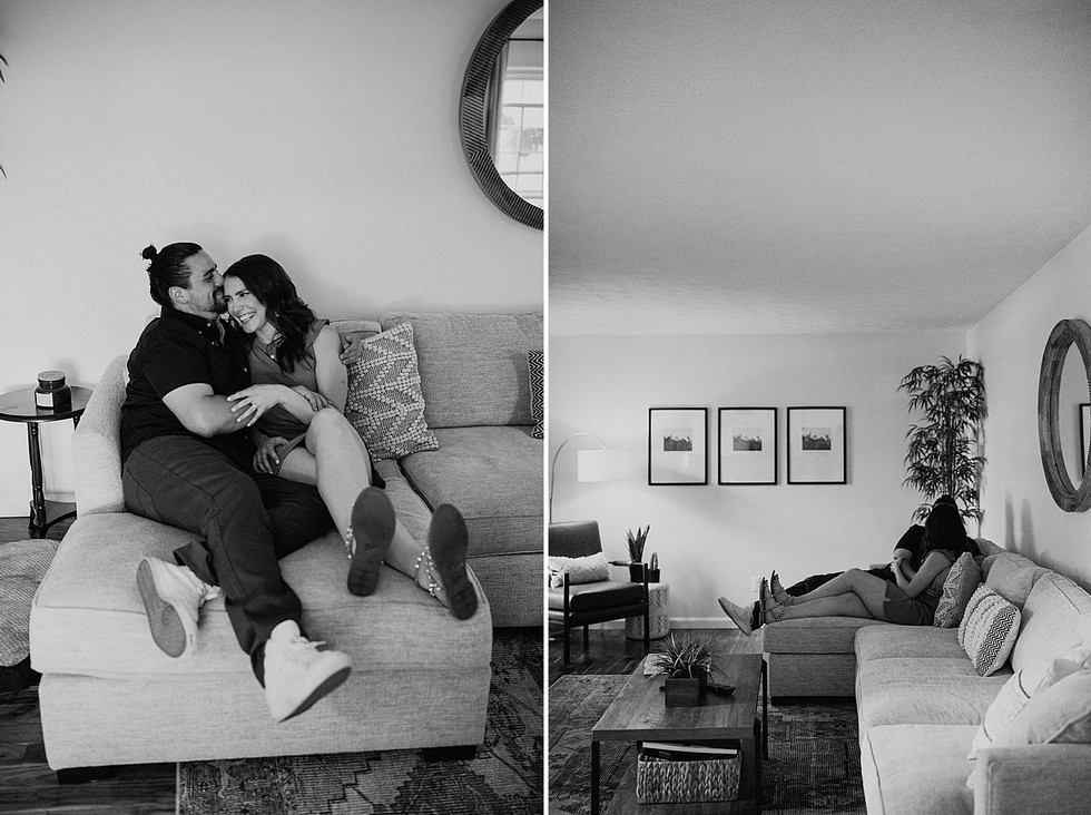 Black and white photos of a couple sitting on a couch in their living room laughing