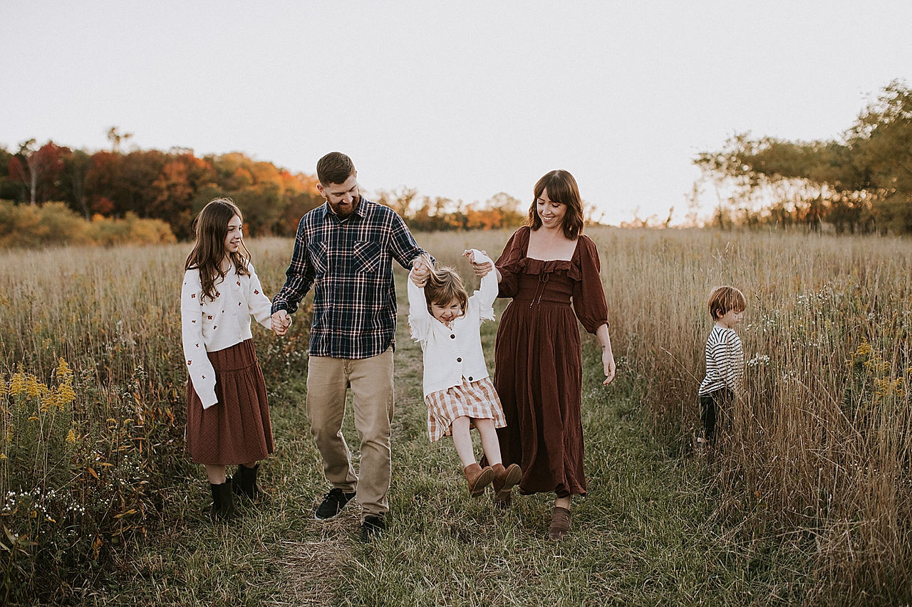 family walking through a field together