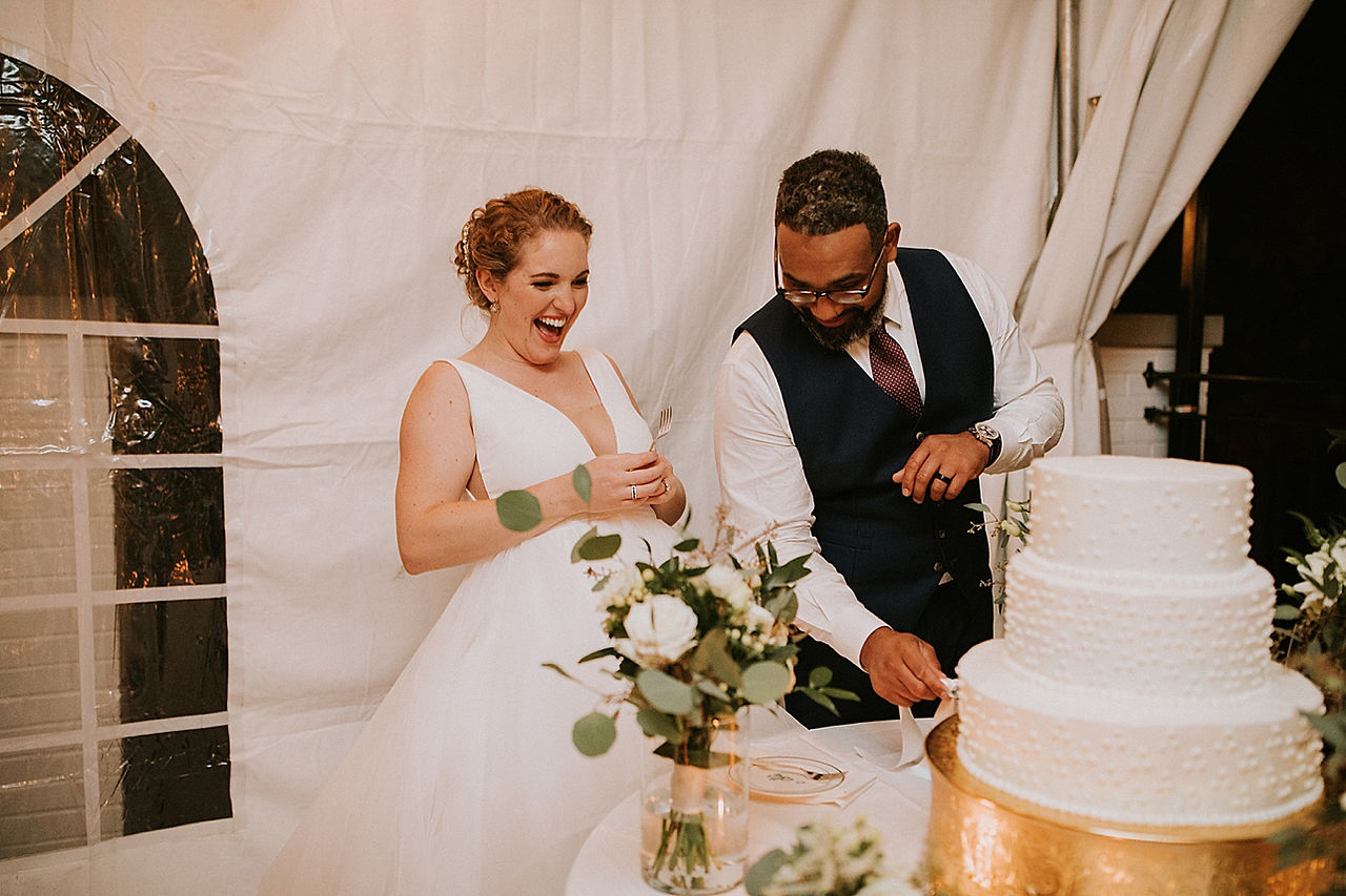 Bride and groom cutting cake