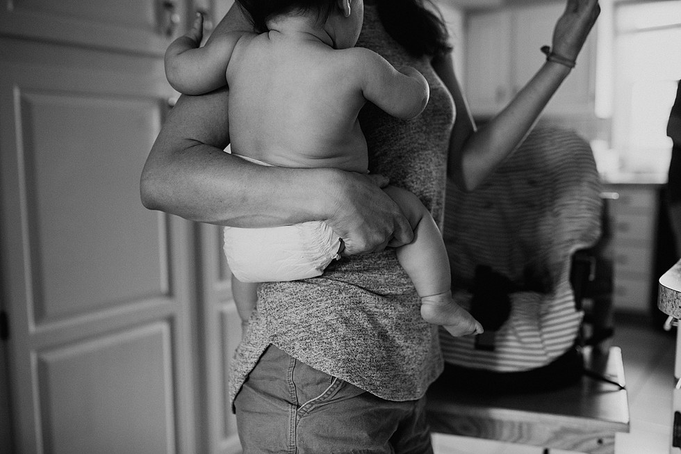 Mother carrying child around on her hip