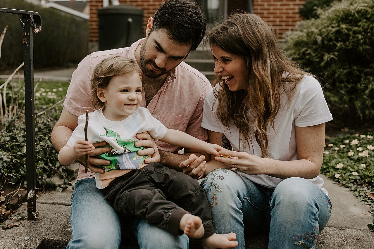 Kid laughing with parents