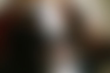 Couple holding their dogs and smiling during portrait session