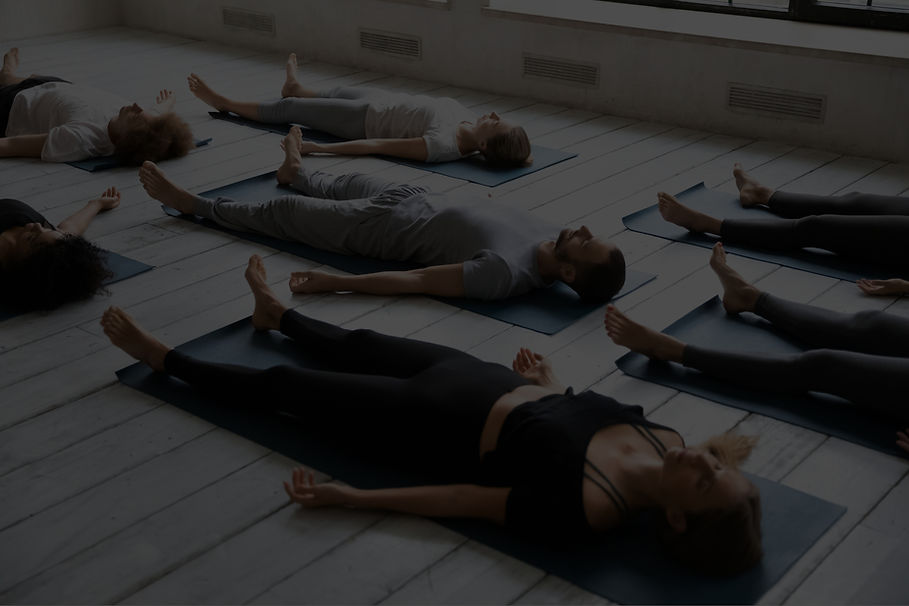 young-sporty-people-with-closed-eyes-meditating-savasana-pose-floor-practicing-yoga-group-