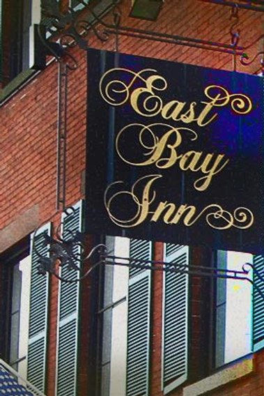 Sign for the East Bay Inn against brick backdrop