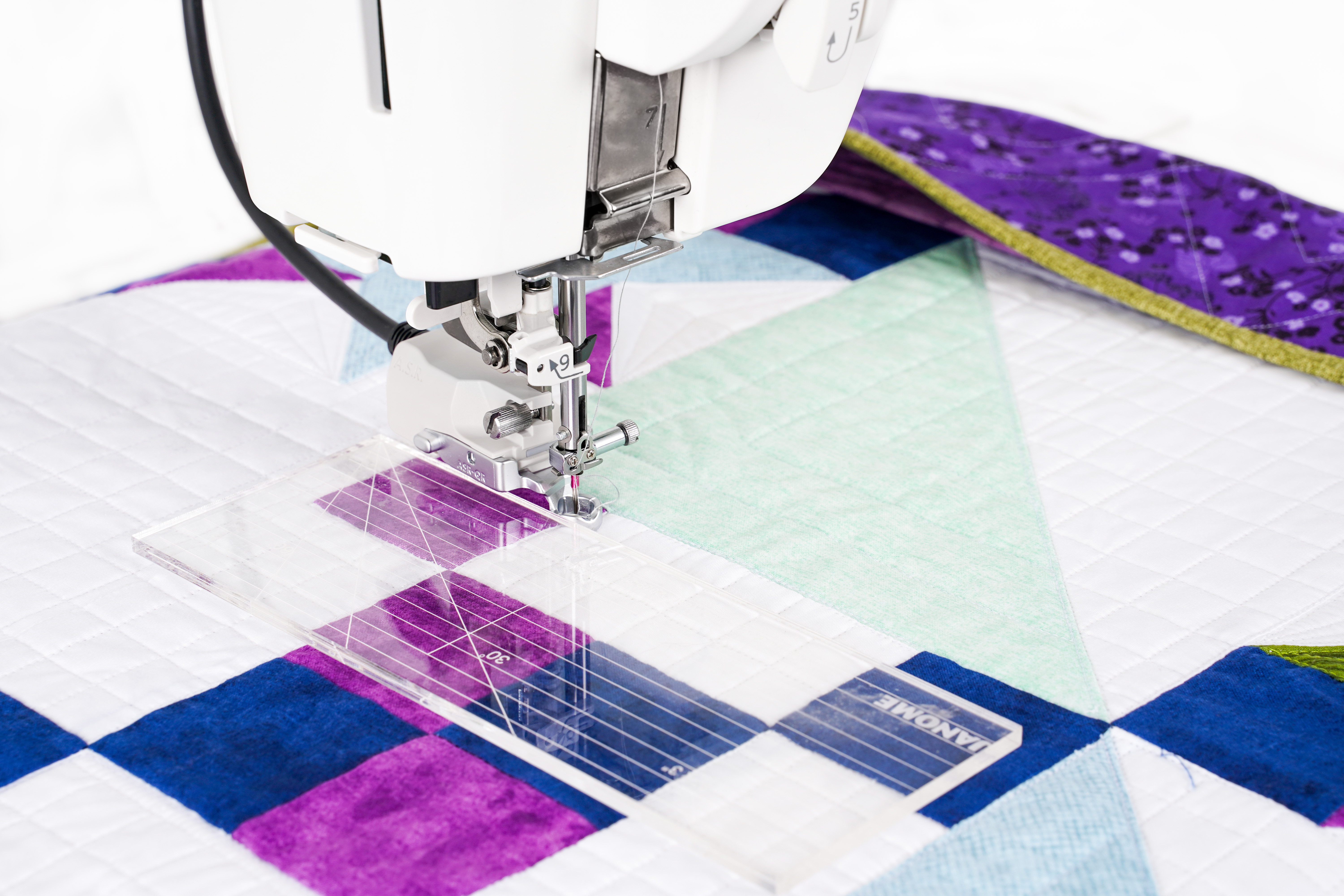 Janome Continental M8 Professional A.S.R. Accurate Stitch Regulator quilting a patchwork quilt