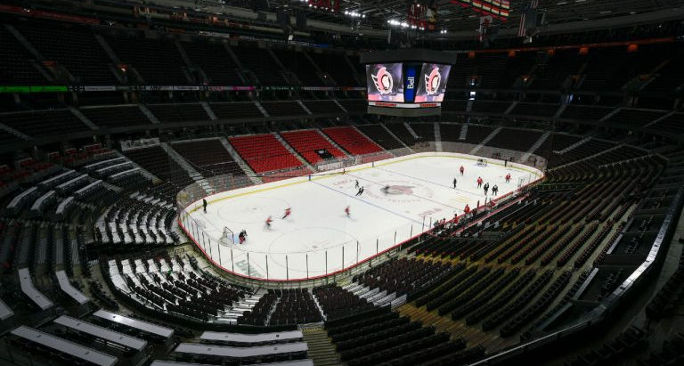 The Canadian Tire Centre arena with no fans in the seats but the team practicing on the ice.