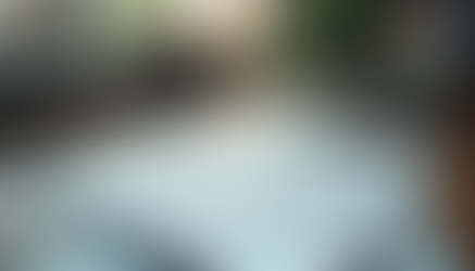 High angle view of a modern workspace with a laptop and design sketches