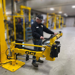 Operator working with a GCI ergonomic assist arm at an assembly station, represented by M6 Revolutions in Washington, Oregon, Idaho, and Canada