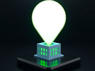 Glowing white map pin atop a tiny building on a dark phone screen, with neon green windows and reflections.