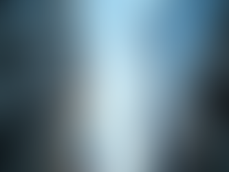 Looking up at three skyscrapers with glass and concrete facades under a clear blue sky, creating a sense of soaring height and openness.