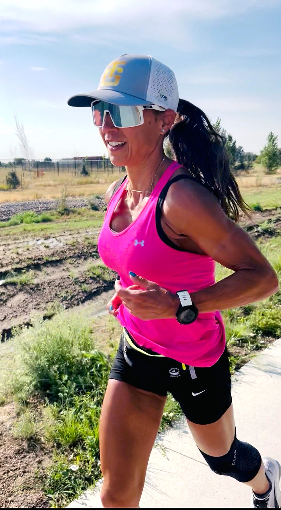 Eye-level view of a runner’s foot landing on uneven trail terrain