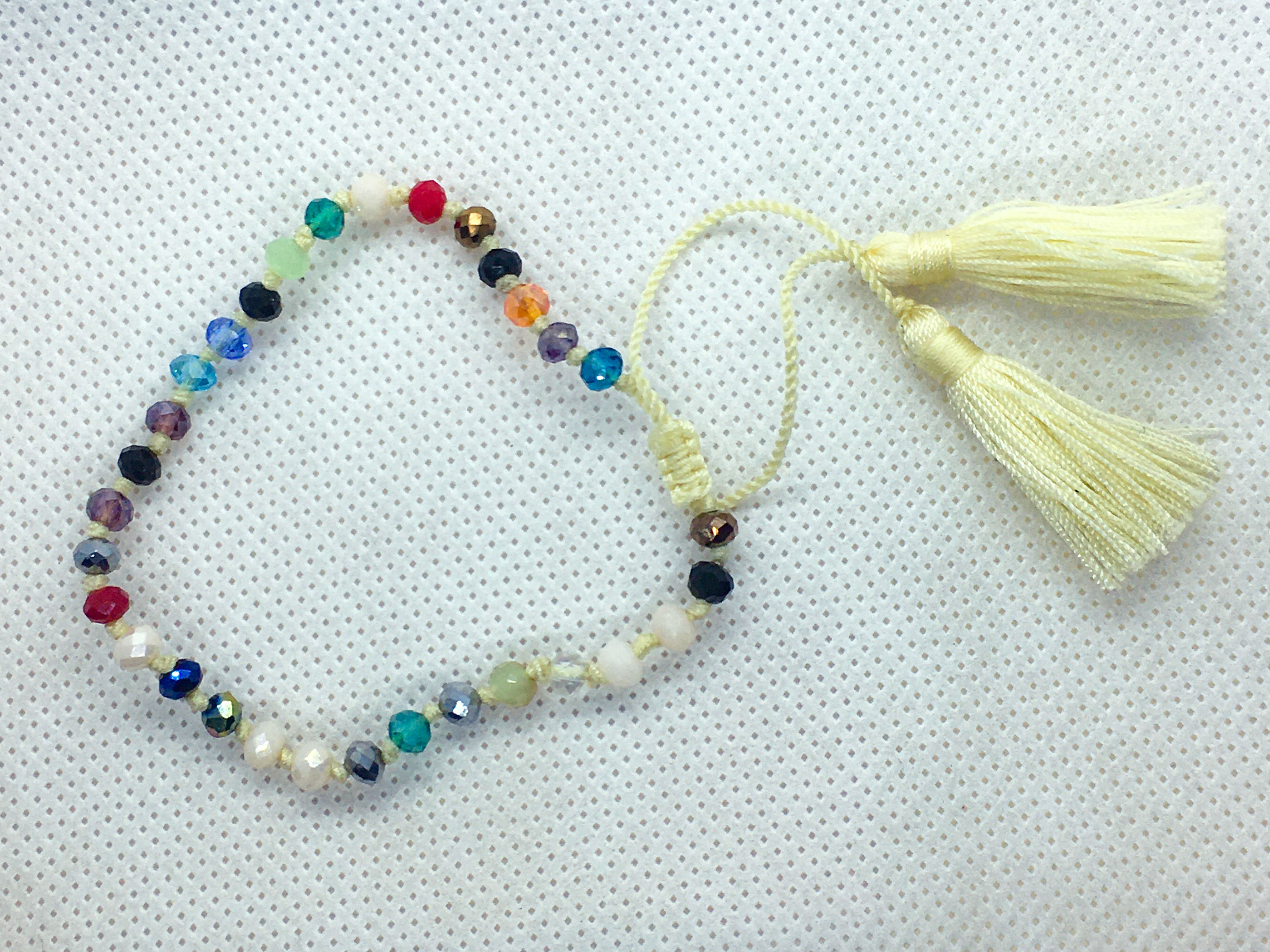 Adjustable tassel bracelet pale yellow