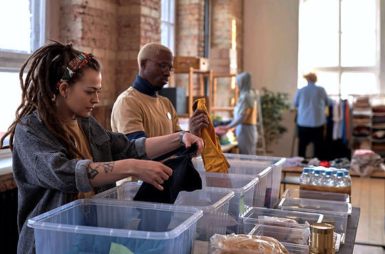 The Clutterless Company's Professional Organizing team working at the company warehouse in New York City. The team is decluttering, sorting, and organizing inventory to offer clients a unique one of a kind experience.