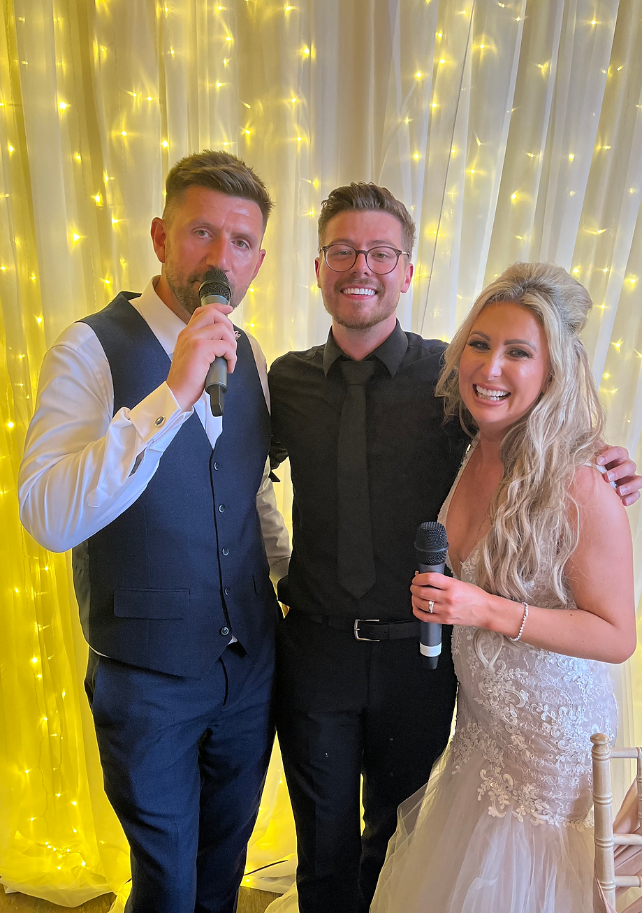 a couple with their surprise singing waiter