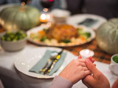 Family holding hands at Thanksgiving table