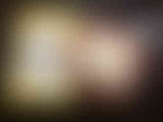 Colorful plate with a Mickey Mouse shaped marshmallow treat and a Goofy's Candy Co. menu on a dark table. Menu lists desserts and toppings.