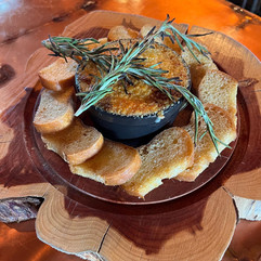 toast points and a savory dip served on a round platter