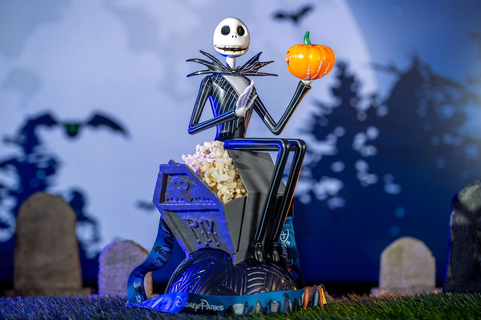 Skeleton figure holds pumpkin and popcorn in graveyard setting. Blue and gray tones with eerie mood. "Disney Parks" text visible.
