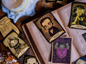 Creepy Gideon's Bakehouse character cards on an open book, surrounded by lit candles and a cookie. Dark, eerie mood with muted colors and gothic art.