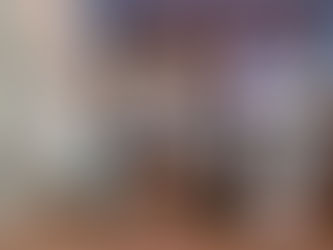 Mickey and Minnie in winter outfits, posing with skis and a snowboard indoors. A snowy tree and mugs of cocoa are nearby. Cozy atmosphere.