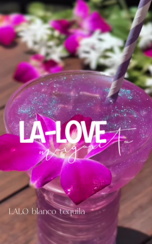 Purple margarita with glitter and orchid, striped straw. Text reads "LA-LOVE margarita" and "LALO blanco tequila." Floral background.