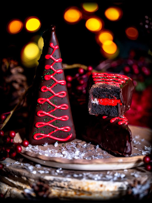 Gideon's Bakehouse Krampus Shadow Cake - A slice of cake dipped in chocolate.