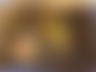 Buffalo style hot dog covered in mustard and other condiments with a side of a vegatable mix including cauliflower and carrots