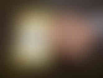 Colorful Mickey-shaped treat with sprinkles on a festive plate next to a "Create Your Own Treat" menu on a dark countertop.