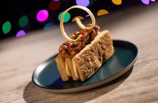 layered cookie with cream between the layers with a decorative twirl on top