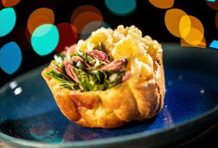 finger food with an open pastry and a greens and cheese type filling