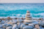zen-balanced-stones-stack-on-beach-ANDB7WG-scaled.jpg