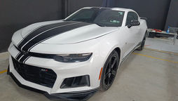 Certified technician inspecting a Chevrolet vehicle