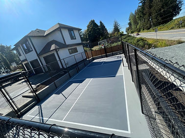 Chain link fence with surrounding valley stone walls and garden boxes