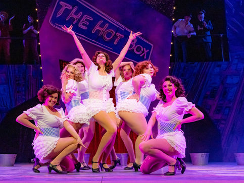 Burlesque dancers pose at the end of a dance number.