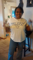 Smiling woman wearing a shirt with text Get Your People Up.