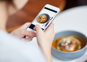 Woman taking a picture of her meal