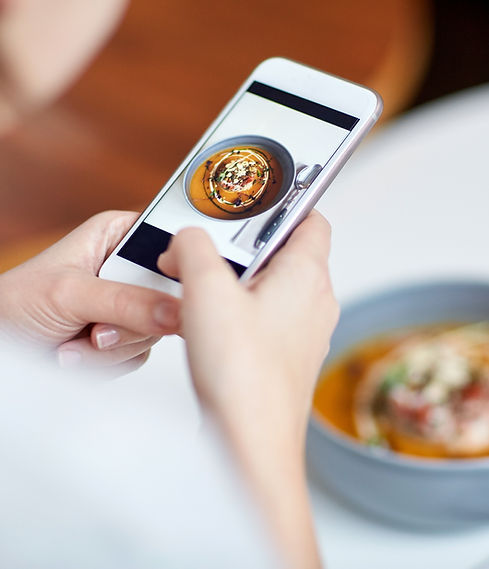Woman taking a picture of her meal