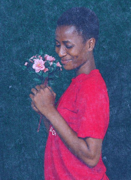 a woman in a red shirt holding a bouquet