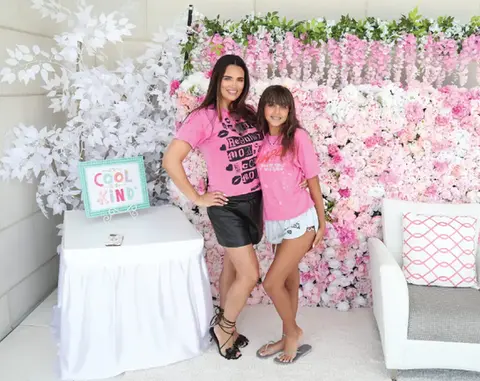 Two women in pink shirts at a 'COOL KIND' event