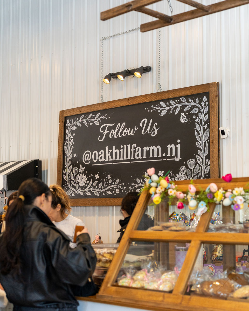 Vendor at Oak Hill Farm indoor market with chalkboard menu GEO targeted | Oak Hill Farm, Holmdel, NJ