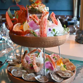 Two-tiered seafood tower with lobster, crab, shrimp, oysters